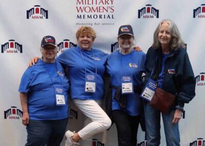"Four women veterans stand together at the Women’s Memorial, reflecting on their military service and honoring the contributions of women in the armed forces."