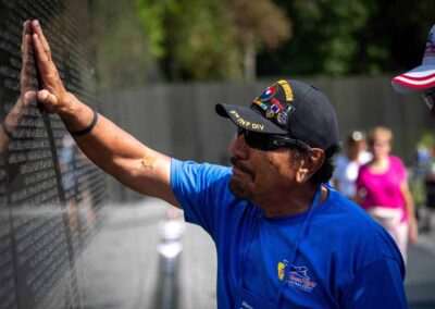 Veteran touching the names on the Vietnam Veterans Memorial Wall in Washington, D.C.